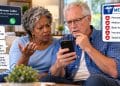 Older Black wife and white husband on couch concerned about suspicious Medicare phone call and requests for personal information